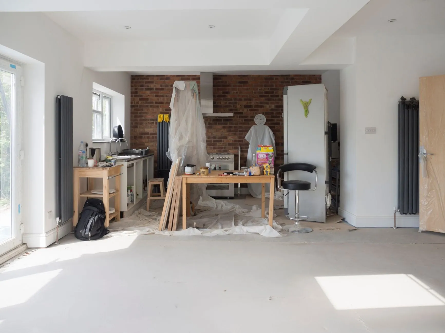 A bright converted ground-floor room mid-fit, with new radiators, rooflights and a dust-sheeted kitchen area